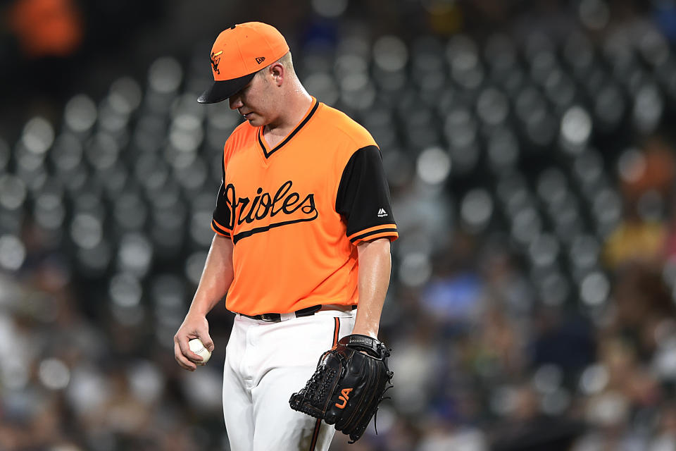 Baltimore Orioles' Dylan Bundy reacts after giving up a walk to the New York Yankees during the third inning of a baseball game Sunday, Aug. 26, 2018, in Baltimore. (AP Photo/Gail Burton)