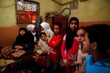 Egyptian children stand next to their grandmother at their house in the province of Fayoum, southwest of Cairo, Egypt February 19, 2019. Picture taken February 19, 2019. REUTERS/Hayam Adel