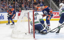 Vancouver Canucks goalie Arturs Silovs (31) can't stop a goal by Edmonton Oilers' Leon Draisaitl (29) as Zach Hyman (18) watches the puck go in the net during the second period of Game 3 of an NHL hockey Stanley Cup second-round playoff series in Edmonton, Alberta, Sunday, May 12, 2024. (Jason Franson/The Canadian Press via AP)