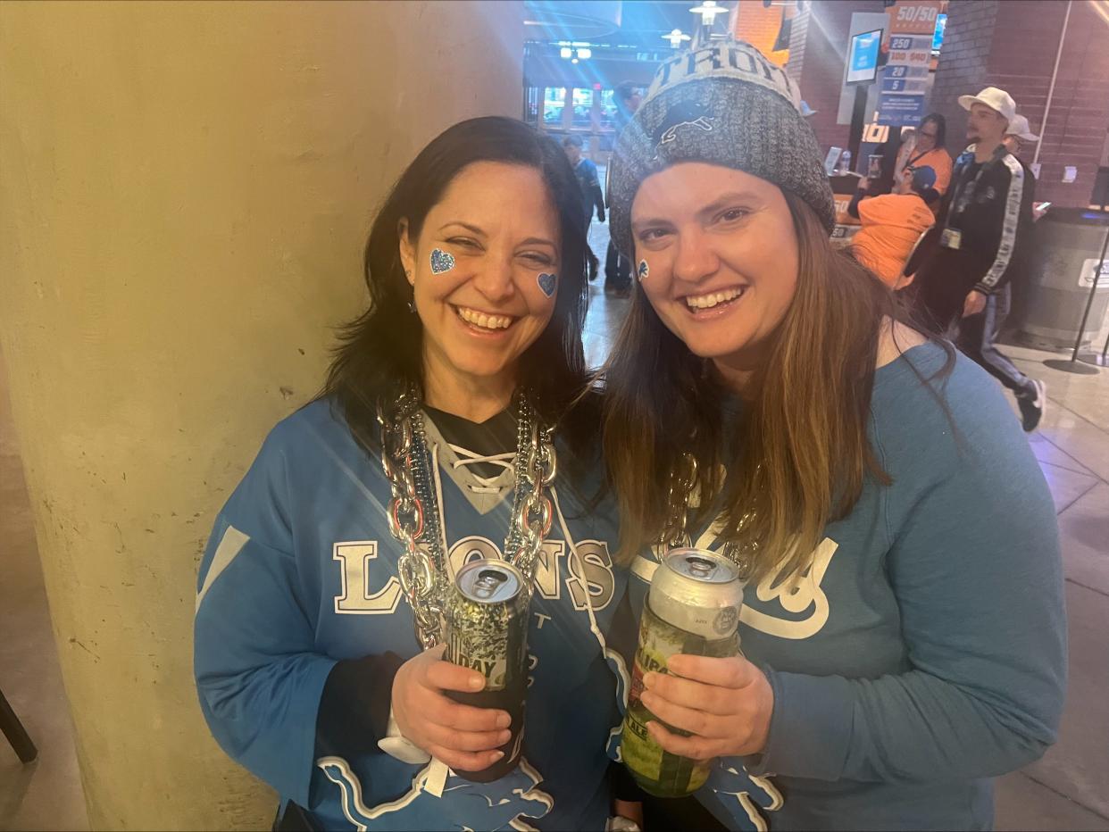 Laura Borruiker, 47, of Redford, and Sam Nowrocki, 35, of Detroit, enjoy a beer as they wait on the Ford Field concourse at halftime of the game between the Detroit Lions and Tampa Bay Buccaneers.