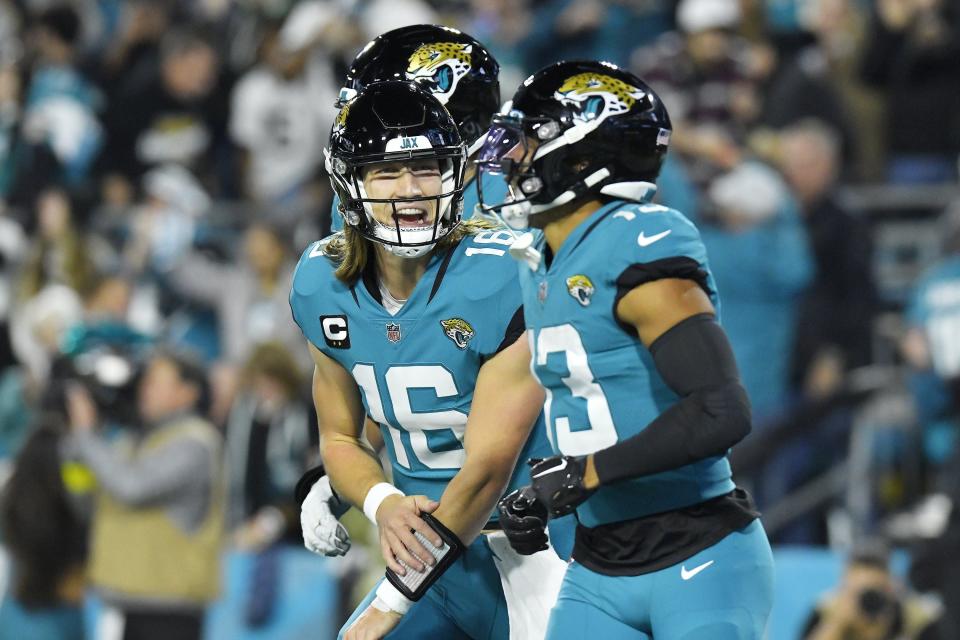 Jacksonville Jaguars quarterback Trevor Lawrence (16) celebrates with teammate wide receiver Christian Kirk (13) after his touchdown catch during second quarter action. The Jacksonville Jaguars hosted the Tennessee Titans to decide the AFC South championship at TIAA Bank Field in Jacksonville, FL, Saturday, January 7, 2023. The Jaguars went into the half trailing 7 to 13. [Bob Self/Florida Times-Union]