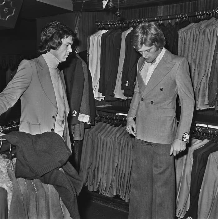 Two Leeds United footballers in a clothing store trying on suits