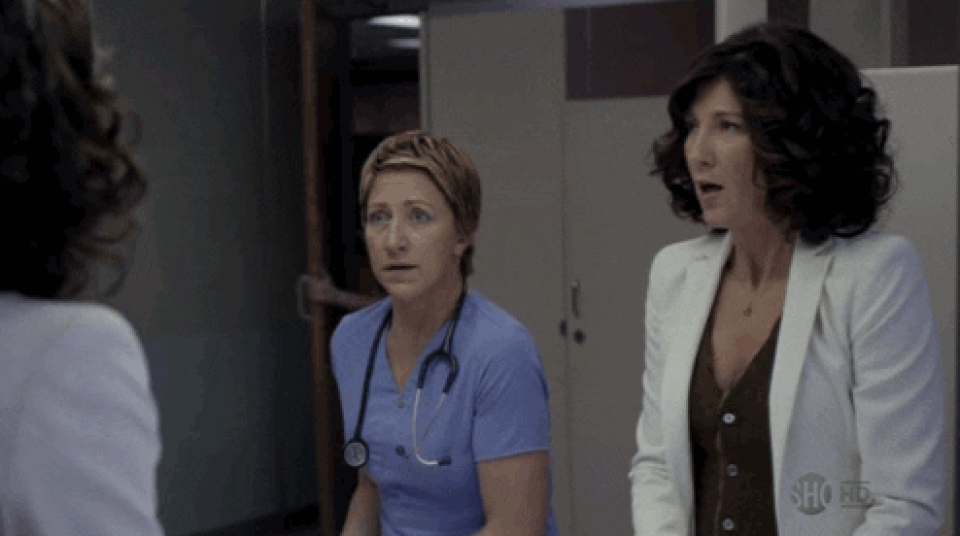 Edie Falco in "Nurse Jackie" talking to a woman in the bathroom