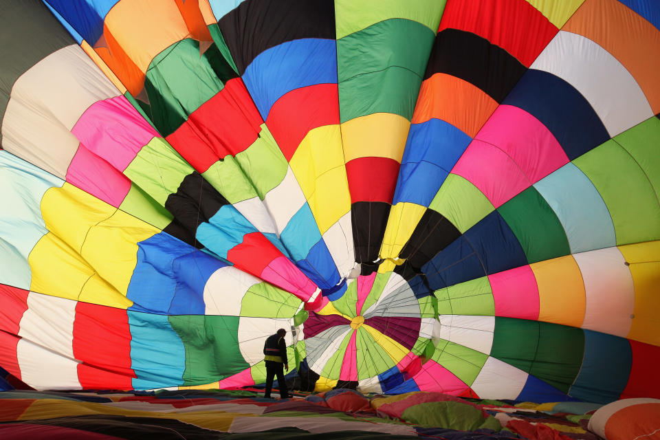 WOOTTON, UNITED KINGDOM - APRIL 07: Hot air balloons prepare to depart from Lydden Hill race circuit near Canterbury to take part in mass crossing of the Channel on April 7, 2011 in Wootton, England. 51 balloonists of various nationalities from across Europe took off from Kent making for Calais, France at about 7am. It is the first time a Guinness World Record bid has been made for "the largest group of hot air balloons to make the Channel crossing". (Photo by Oli Scarff/Getty Images)