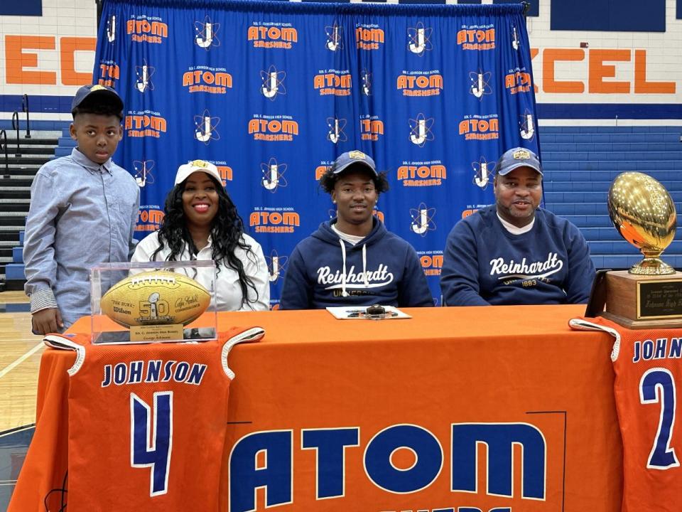 Michael Ellison III of Johnson, with his family, as he signed to play football at Reinhardt University Wedneday.