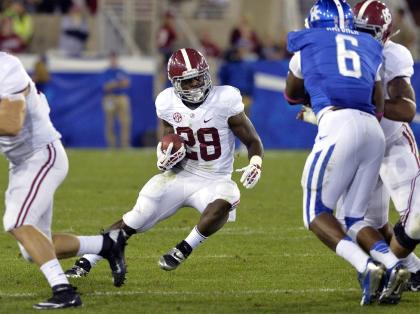 Alabama's Altee Tenpenny finds an opening in the Kentucky defensive line during the fourth quarter of an NCAA college football game, Saturday, Oct. 12, 2013, at Commonwealth Stadium in Lexington, Ky. Alabama defeated Kentucky 48-7. (AP Photo/Timothy D. Easley)
