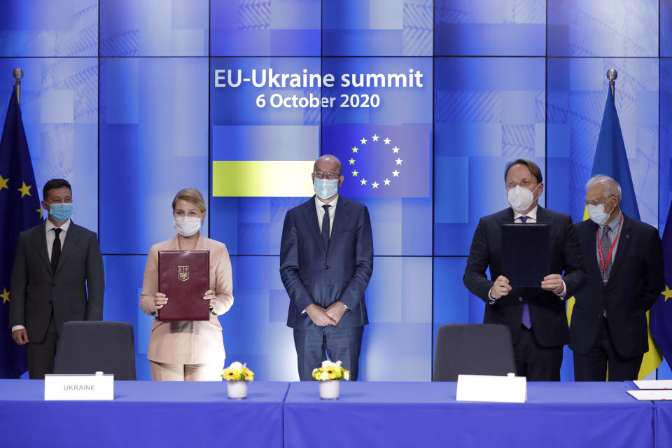 Ukrainian President Volodymyr Zelenskiy, Ukrainian Deputy Prime Minister for European and Euro-Atlantic Integration Olga Stefanishyna, European Council President Charles Michel, European Commissioner for Neighbourhood and Enlargement Policy Oliver Varhelyi and European Union foreign policy chief Josep Borrell, from left to right, attend a signing ceremony during a EU-Ukraine summit at the European Council in Brussels, Tuesday, Oct. 6, 2020. (Stephanie Lecocq/Pool Photo via AP)