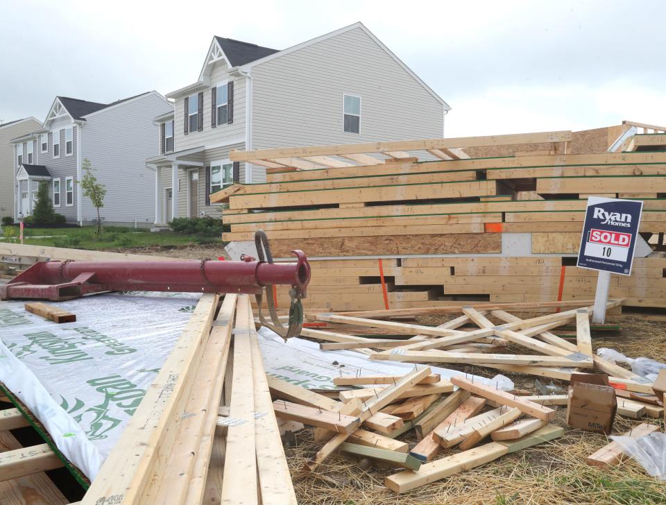 Building materials sit at the site where residences are being constructed on Himelrigh Boulevard in the East New Haven development on Thursday in Barberton.