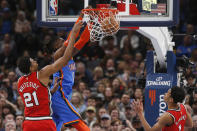 Oklahoma City Thunder center Nerlens Noel (9) dunks between Portland Trail Blazers center Hassan Whiteside (21) and guard Anfernee Simons (1) in the first half of an NBA basketball game Saturday, Jan. 18, 2020, in Oklahoma City. (AP Photo/Sue Ogrocki)