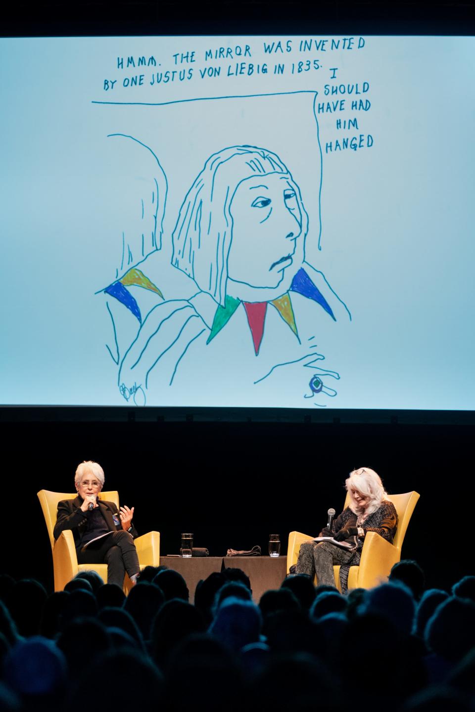 Joan Baez, left, speaks about new book of drawings, Am I Pretty When I Fly? An Album of Upside Down Drawings, with Emmylou Harris, right, at OZ Arts in Nashville, Tenn., Saturday, April 8, 2023.