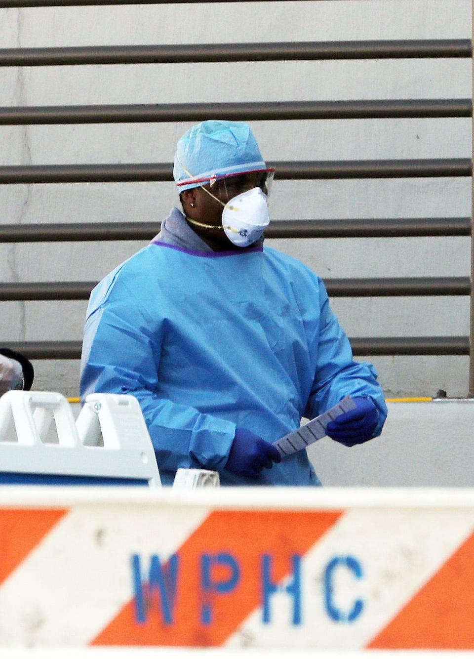 A medical worker walks out of a Coronavirus screening tent set up outside the emergency room at White Plains Hospital in New York on March 21, 2020.