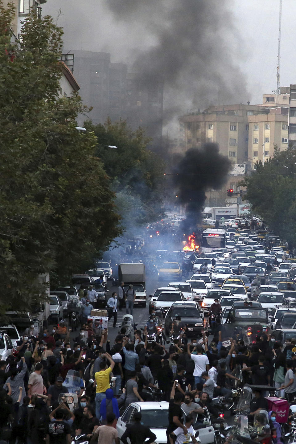 In this Wednesday, Sept. 21, 2022, photo taken by an individual not employed by the Associated Press and obtained by the AP outside Iran, protesters chant slogans during a protest over the death of a woman who was detained by the morality police, in downtown Tehran, Iran. Iranians saw their access to Instagram, one of the few Western social media platforms still available in the country, disrupted on Wednesday following days of the mass protests. (AP Photo)