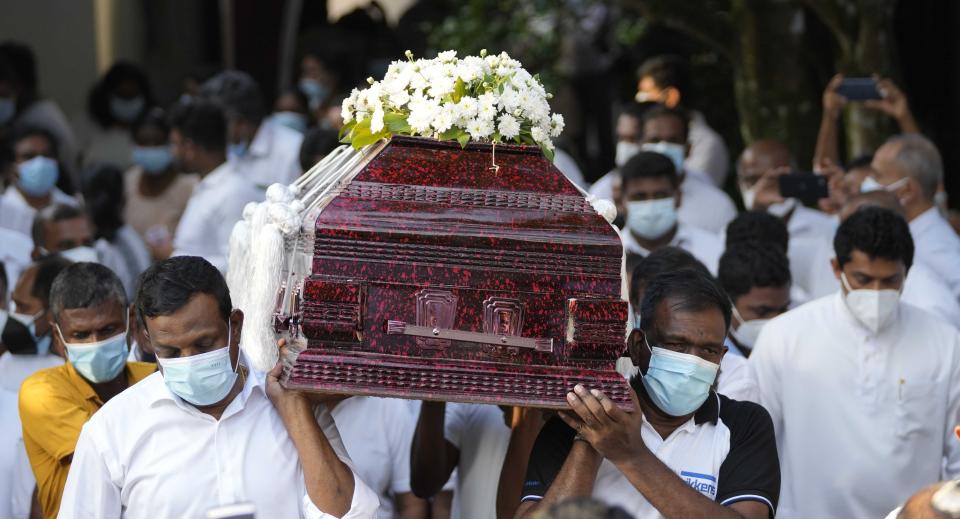 Family members of Sri Lankan factory manager Priyantha Kumara who was lynched by a Muslim mob in Pakistan for alleged blasphemy carry his casket to a cemetery during his burial in Colombo, Sri Lanka, Wednesday, Dec. 8, 2021. (AP Photo/Eranga Jayawardena)