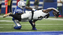 New Orleans Saints running back Alvin Kamara (41) reaches to score on an 18-yard touchdown reception as Indianapolis Colts linebacker Shaquille Leonard (53) defends during the first half of an NFL football game Sunday, Oct. 29, 2023 in Indianapolis. (AP Photo/Darron Cummings)