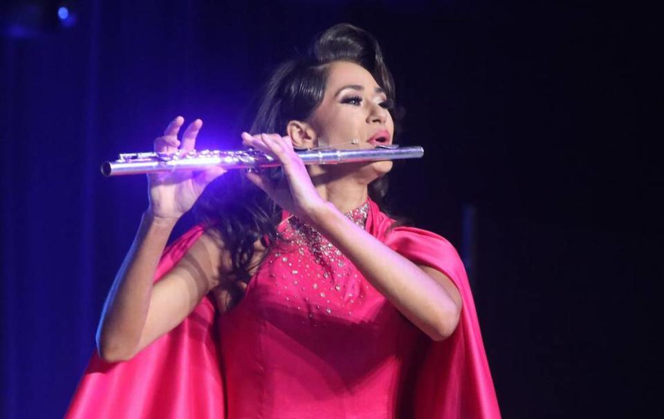 Miss Tulare County Elizabeth Sartuche plays the flute during the Miss California Pageant held at the Visalia Convention Center on July 1, 2023.