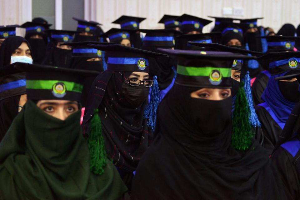 In this file photo taken on 17 March 2022, students from the faculties of Engineering and Computer Science attend their graduation ceremony at Benawa University in Kandahar (AFP via Getty Images)