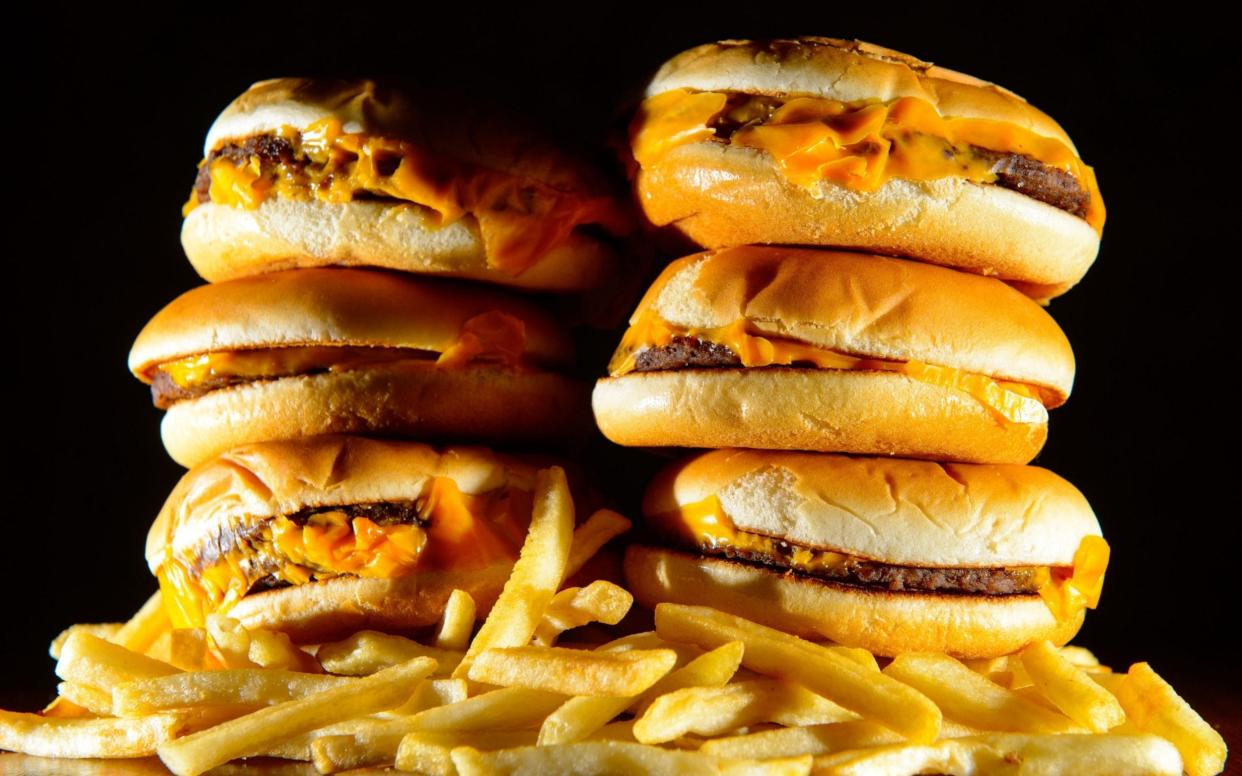 File photo dated 09/07/14 of a pile of cheeseburgers and french fries - PA