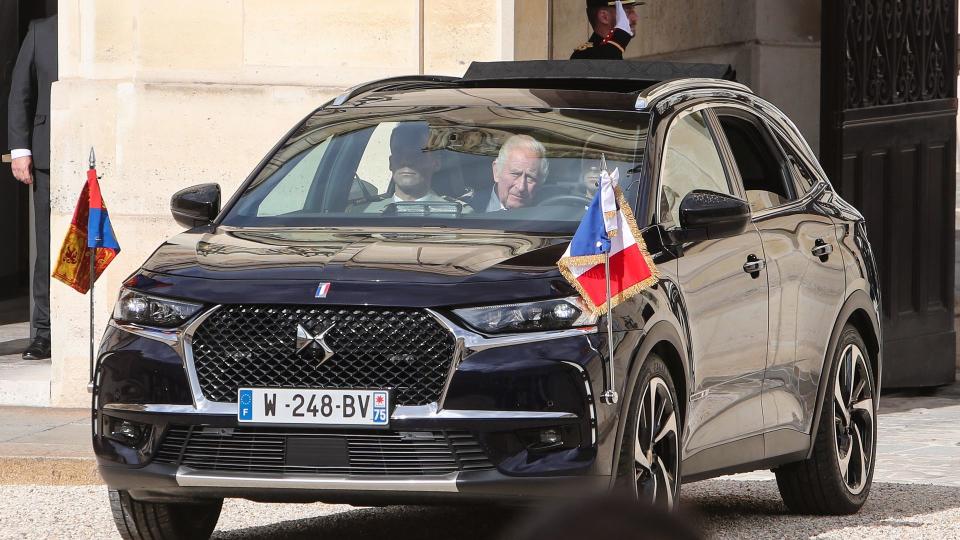 King Charles in the back of a car