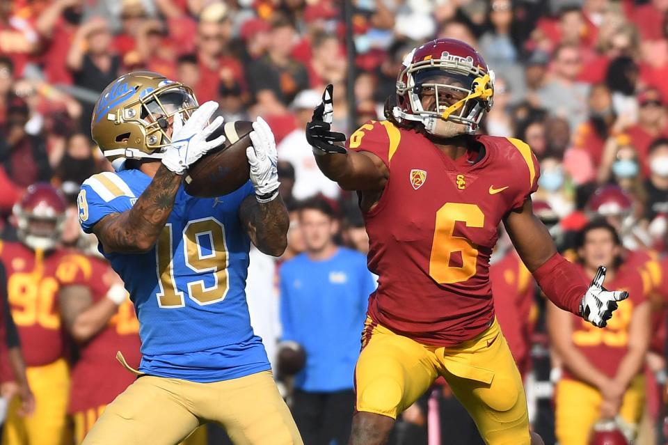 UCLA running back Kazmeir Allen (19) catches a touchdown pass against USC cornerback Isaac Taylor-Stuart.