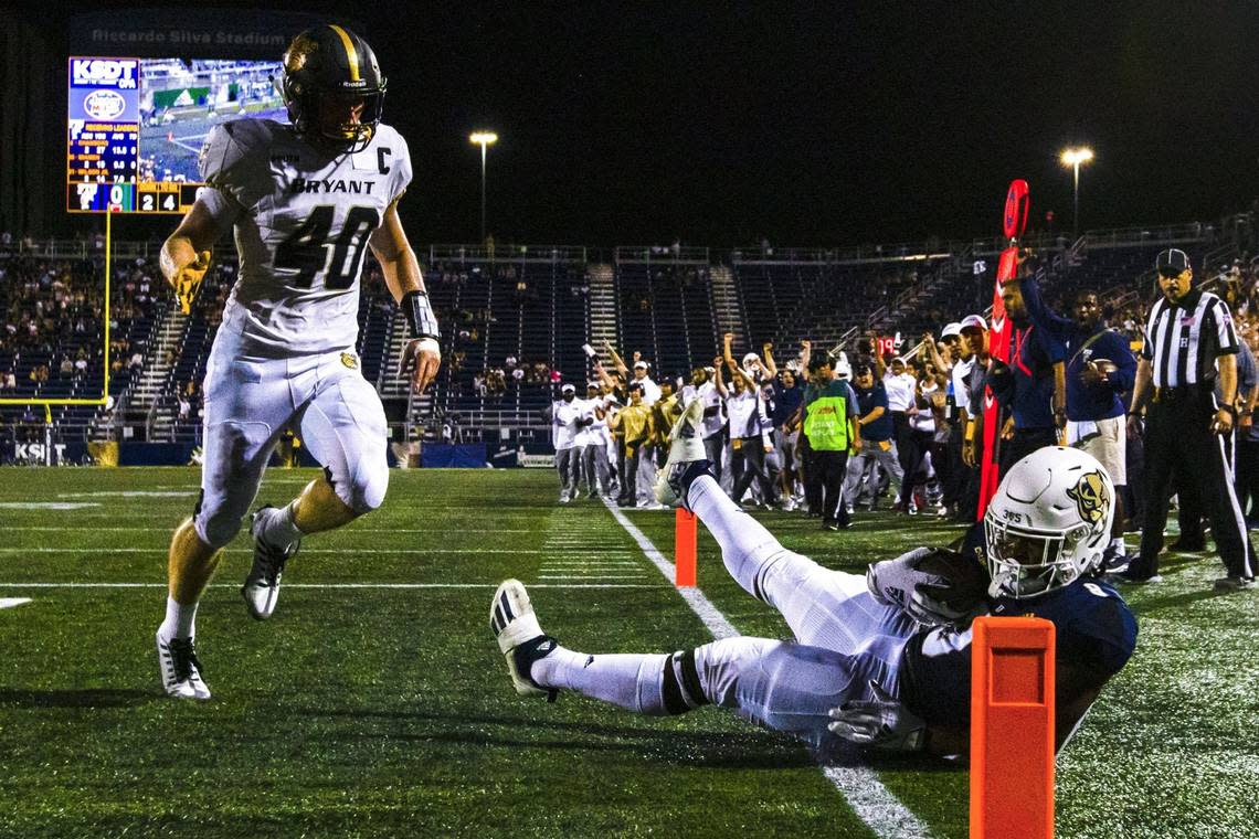 Florida International University running back Lexington Joseph (8) scores a touchdown while covered by Bryant University linebacker Ryan Saddler (40) during the second quarter of an NCAA Conference USA football game at Riccardo Silva Stadium in Miami, Florida, on Thursday, September 1, 2022.