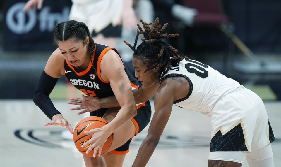 Oregon State guard Talia von Oelhoffen, left, fights for control of the ball with Colorado guard Jaylyn Sherrod, right, in the second half of an NCAA college basketball game Sunday, Feb. 11, 2024, in Boulder, Colo. (AP Photo/David Zalubowski)