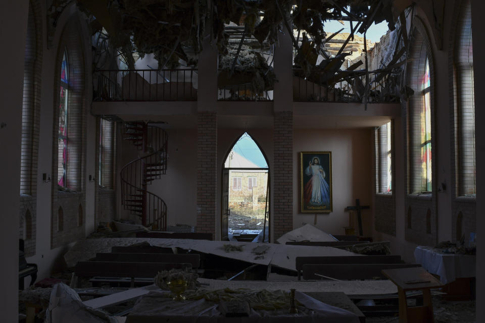 A hole in the roof of the Catholic cathedral damaged by Russian shelling in Bakhmut, the site of the heaviest battles with the Russian troops, in the Donetsk region, Ukraine, Sunday, Dec. 11, 2022. (AP Photo/Andriy Andriyenko)