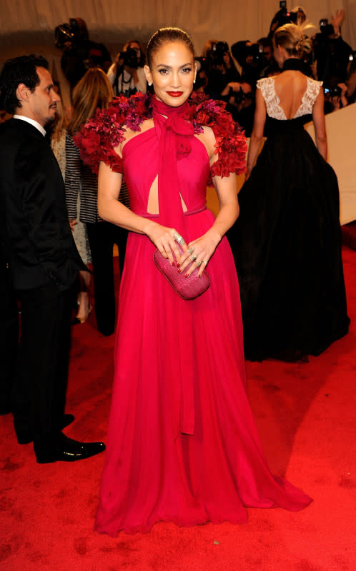 <p>Kevin Mazur/WireImage</p><p>Jennifer Lopez went full-on girly in this Gucci magenta gown with deep red flowers on the shoulders, a matching clutch and coordinating crimson lips for the 2011 Met Gala, "Alexander McQueen: Savage Beauty."</p>