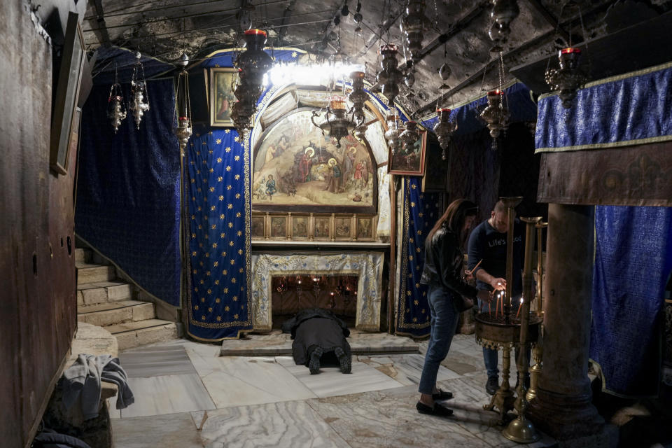 People visit the Grotto, under the Church of the Nativity, traditionally believed to be the birthplace of Jesus Christ in the West Bank town of Bethlehem, Saturday, Dec. 16, 2023. World-famous Christmas celebrations in Bethlehem have been put on hold due to the ongoing Israel-Hamas war. (AP Photo/Mahmoud Illean)