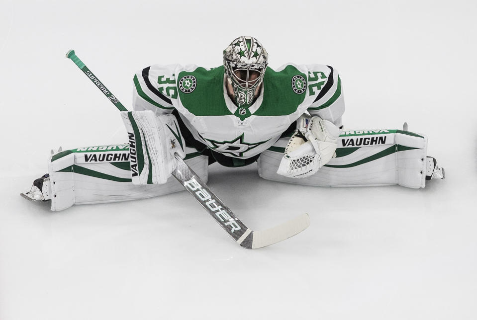 Dallas Stars goalie Anton Khudobin (35) stretches during a warm-up before an NHL Western Conference Stanley Cup playoff game against the Dallas Stars, in Edmonton, Alberta, on Monday, Aug. 24, 2020. (Jason Franson/The Canadian Press via AP)