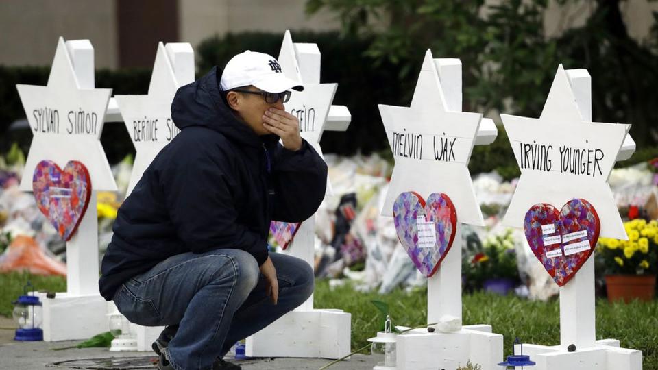 A person on Monday pauses in front of Stars of David with the names of those killed in a deadly shooting at the Tree of Life Synagogue in Pittsburgh. (Matt Rourke/AP)