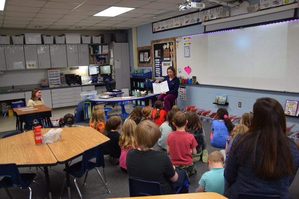 Dr. Kara Henning reads to a classroom about the best and safest ways to approach dogs. The students got to take home the coloring books with helpful tips like never letting a dog get close to your face.