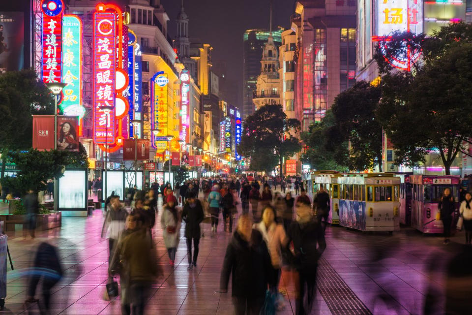 Street in China with shoppers at night. 