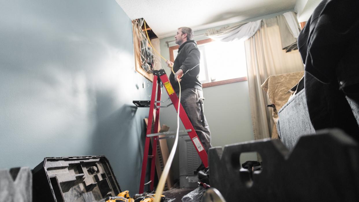 Electrician upgrading a homes electrical panel.