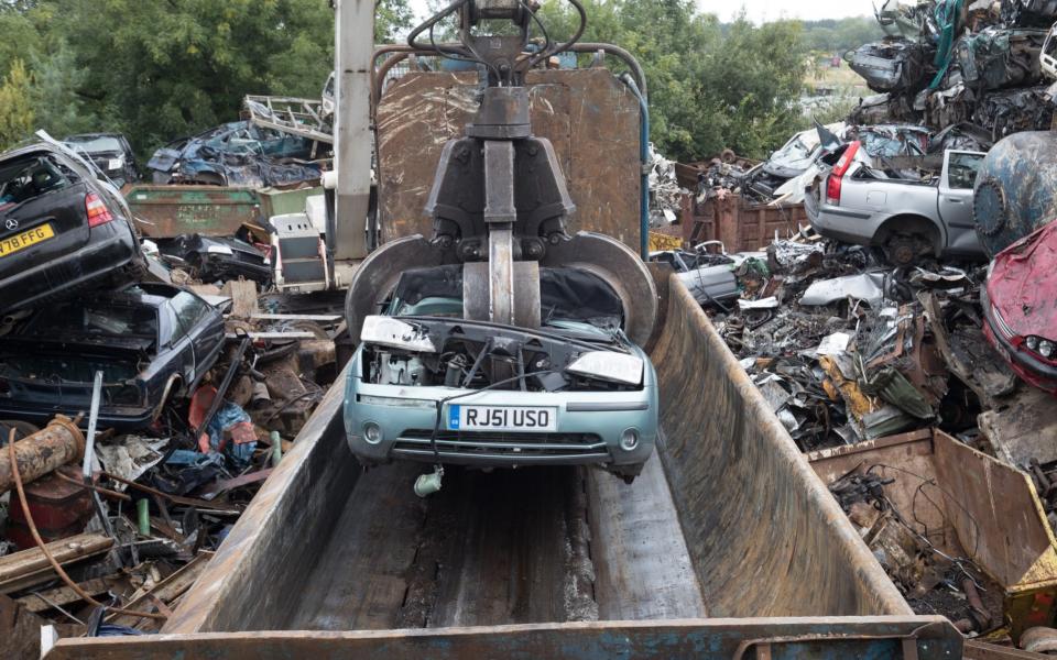 scrap car being placed into a crusher at scrapyard - Matt Cardy/Getty Images