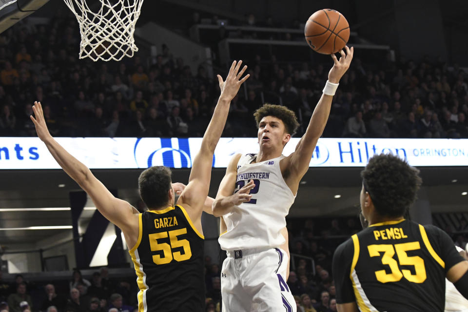 Northwestern forward Pete Nance (22) shoots over Iowa center Luka Garza (55) during the second half of an NCAA college basketball game Tuesday, Jan. 14, 2020, in Evanston, Ill. (AP Photo/David Banks)