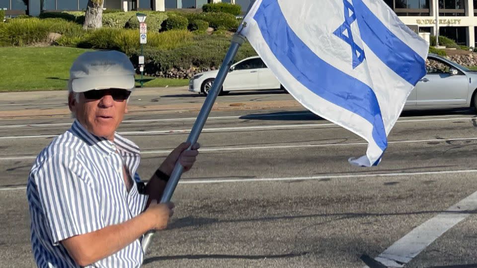 This photo, taken Sunday, shows Paul Kessler holding an Israeli flag at the intersection where the altercation would later take place. - from X