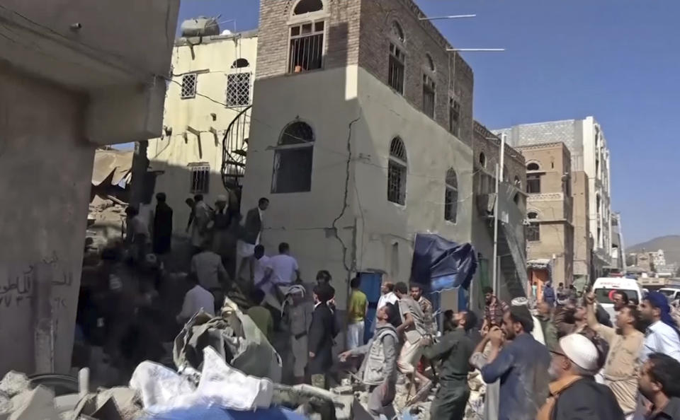 In this frame grab from from video, people search in the rubble following Saudi-led coalition airstrikes that killed at least six, including children, officials said, in the residential center of the capital, Sanaa, Yemen, Thursday, May 16, 2019. The Sanaa airstrikes came after Yemen's Iran-backed Houthi rebels, who control the capital, launched a drone attack earlier in the week on a critical oil pipeline in Saudi Arabia, Tehran's biggest rival in the region. (AP Photo)