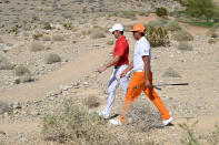 Rory McIlroy, left, of Northern Ireland, and Rickie Fowler walk to the third tee box during final round of the CJ Cup golf tournament, Sunday, Oct. 17, 2021, in Las Vegas. (AP Photo/David Becker)