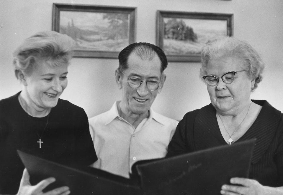 Roller derby star Joan Kazmerski looks at a scrapbook with her parents, Anthony and Alexandra Kazmierski, at their Kent home in 1966.