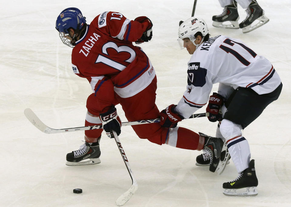 Nicolas Kerdiles of the U.S. checks Czech Republic's Pavel Zacha (L) during the third period of their IIHF World Junior Championship ice hockey game in Malmo, December 26, 2013. REUTERS/Alexander Demianchuk (SWEDEN - Tags: SPORT ICE HOCKEY)