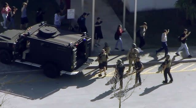 Students are escorted out of the school following the shooting. Source: AAP