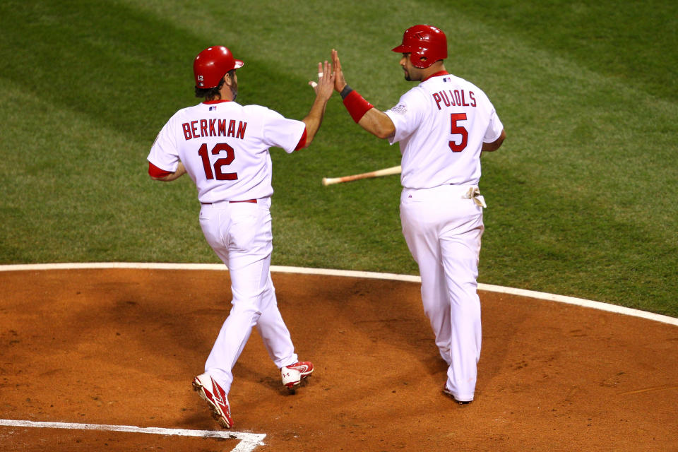 ST LOUIS, MO - OCTOBER 28: Albert Pujols #5 (R) and Lance Berkman #12 of the St. Louis Cardinals celebrate after scoring on a two-run double by David Freese #23 in the first inning during Game Seven of the MLB World Series against the Texas Rangers at Busch Stadium on October 28, 2011 in St Louis, Missouri. (Photo by Dilip Vishwanat/Getty Images)