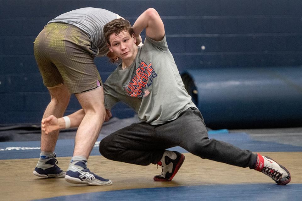 Job Brown, right, wrestles with Henry Stubblefield during practice, February 13, 2024, at Roberson High School.