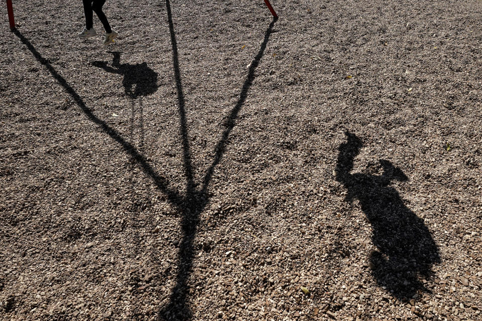 Third graders play on a swing during recess at Highland Elementary School in Columbus, Kan., on Monday, Oct. 17, 2022. Third graders in the tiny 900-student Columbus school district have fought to catch up on reading in the wake of COVID-19 disruptions. (AP Photo/Charlie Riedel)