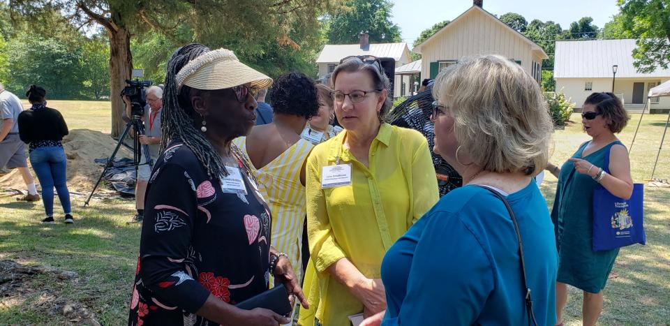 Cassandra McMillion, left, Leisa Greathouse and Mary Holmes talk after a groundbreaking for the main building of the N.C. Civil War & Reconstruction History Center on Thursday, June 2, 2022.