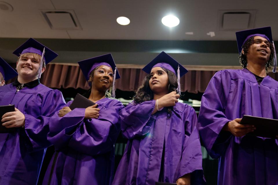 Freshly graduated seniors, from left, Christian Bond, DeAsian Beans, Naudia Barnes and De’Marcus Johnson step up to the front of the stage to be acknowledged during commencement ceremonies at the Academy for Innovative Studies – Diamond Monday evening, May 22, 2023.