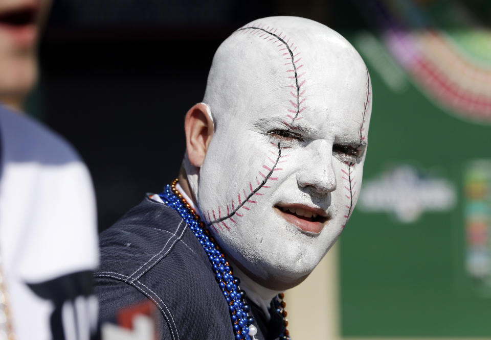 George Uhl, of Sterling Heights, Mich., is made up to look like a baseball before a baseball game between the Detroit Tigers and the Kansas City Royals in Detroit, Monday, March 31, 2014. (AP Photo/Carlos Osorio)