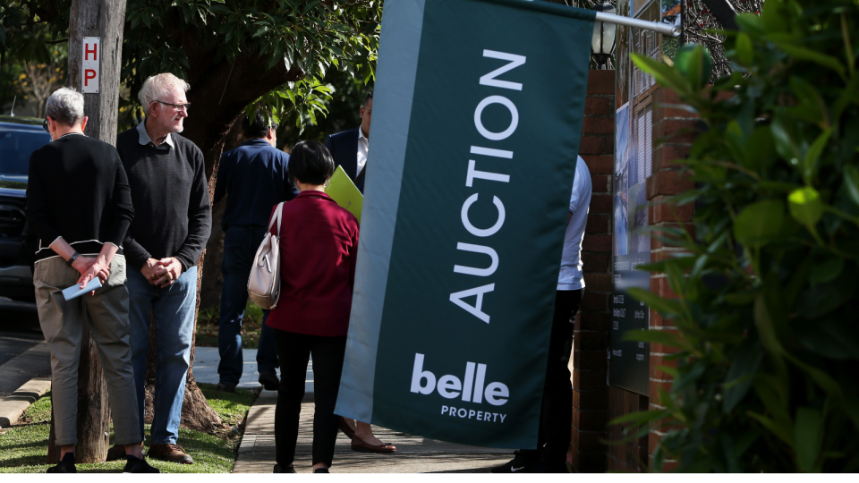 An auction banner is hanging outside an Australian home