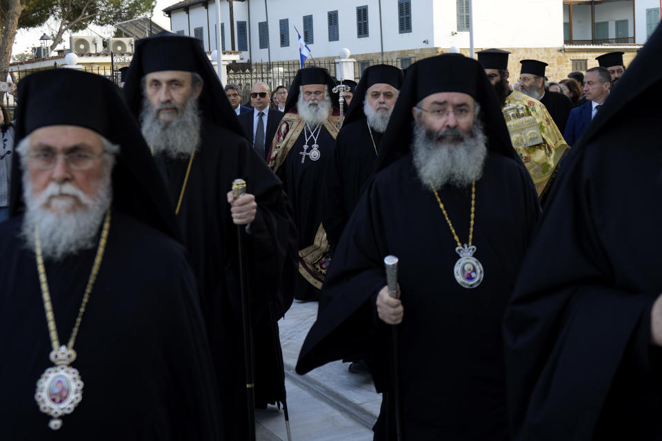 The head of Cyprus' Orthodox Church Archbishop Georgios, rear center, walks with other bishops during his enthronement ceremony at Saint Barnabas Cathedral in capital Nicosia, Cyprus, Sunday, Jan. 8, 2023. Archbishop Georgios formally assumed his new duties following an enthronement ceremony evoking the splendor of centuries of Byzantine tradition before an audience of Orthodox clergy from around the world with the notable exception of the Russian church. The Cyprus Church has recognized the independence of the Orthodox Church of Ukraine. (AP Photo/Petros Karadjias)