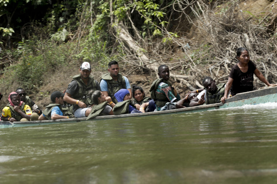 Migrants travel on a dangerously overloaded boat, on the Tuquesa river on their way to Peñitas, from Bajo Chiquito, Darien province, Panama, on Saturday, May 25, 2019. After trekking for days from Colombia, migrants arriving at Bajo Chiquito, feel relief. It's a place to rest, seek sustenance, communicate with loved ones to let them know they're OK and recover their strength, but ahead lies one last trek to safety by boat or by foot. (AP Photo/Arnulfo Franco)